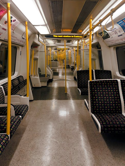 Interior view of a bus or coach featuring beige leather reclining seats with adjustable headrests and armrests, arranged in rows along the aisle. The seats are clean and well-maintained, reflecting su